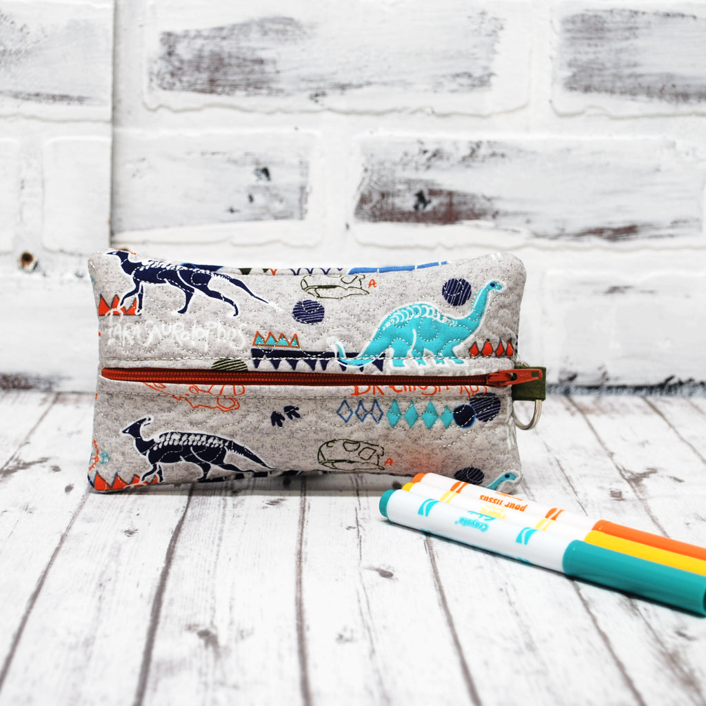 Personalized Teal and orange dinosaurs on gray zippered pencil pouch. 